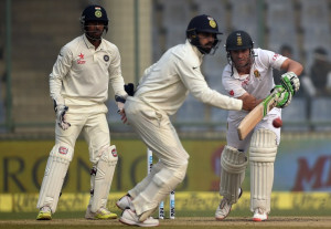 South Africa's AB de Villiers (R) plays a shot as India's wicketkeeper Wriddhiman Saha (L) and India's Murali Vijay (C) looks on during the fifth day of the fourth Test