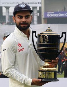 Indian captain Virat Kohli poses with the winning trophy after winning the fourth Test cricket match to take the series between India and South Africa at the Feroz Shah Kotla stadium in New Delhi on December 7, 2015. India beat South Africa by 337 runs in the fourth and final Test