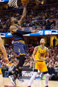 LeBron James #23 of the Cleveland Cavaliers shoots over Stephen Curry #30 of the Golden State Warriors during the second half at Quicken Loans Arena on January 18, 2016 in Cleveland, Ohio. The Warriors defeated the Cavaliers 132-98. NOTE TO USER: User expressly acknowledges and agrees that, by downloading and/or using this photograph, user is consenting to the terms and conditions of the Getty Images License Agreement. Mandatory copyright notice. Jason Miller/Getty Images/AFP