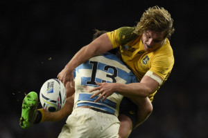 Australia's flanker Michael Hooper (R) is tackled by Argentina's centre Marcelo Bosch during a semi-final match of the 2015 Rugby World Cup between Argentina and Australia at Twickenham Stadium, southwest London, on October 25, 2015. (AFP)