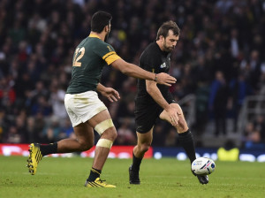 New Zealand's centre Conrad Smith (R) kicks the ball during a semi-final match of the 2015 Rugby World Cup between South Africa and New Zealand at Twickenham Stadium, southwest London, on October 24, 2015. AFP PHOTO / GABRIEL BOUYS RESTRICTED TO EDITORIAL USE, NO USE IN LIVE MATCH TRACKING SERVICES, TO BE USED AS NON-SEQUENTIAL STILLS