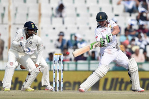South Africa's AB de Villiers (R) bats as India's wicketkeeper Wriddhiman Saha looks on during the third day of the first Test match between India and South Africa