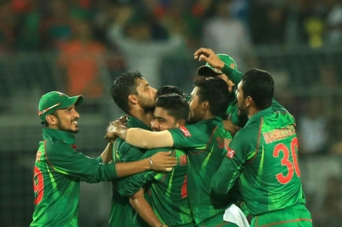 Bangladesh cricketers congratulate Mashrafe Mortaza (2L) after his dismissal of England cricketer Ben Stokes during the second one-day international (ODI) in Dhaka on October 9, 2016