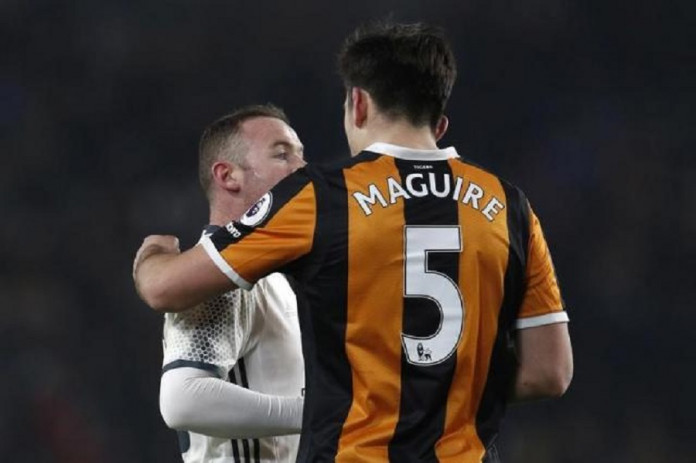 Manchester United's Wayne Rooney and Hull City's Harry Maguire after the match